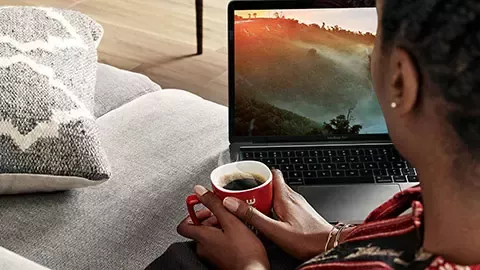 Woman drinks Nescafé coffee at home
