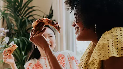 friends enjoying pizza lunch