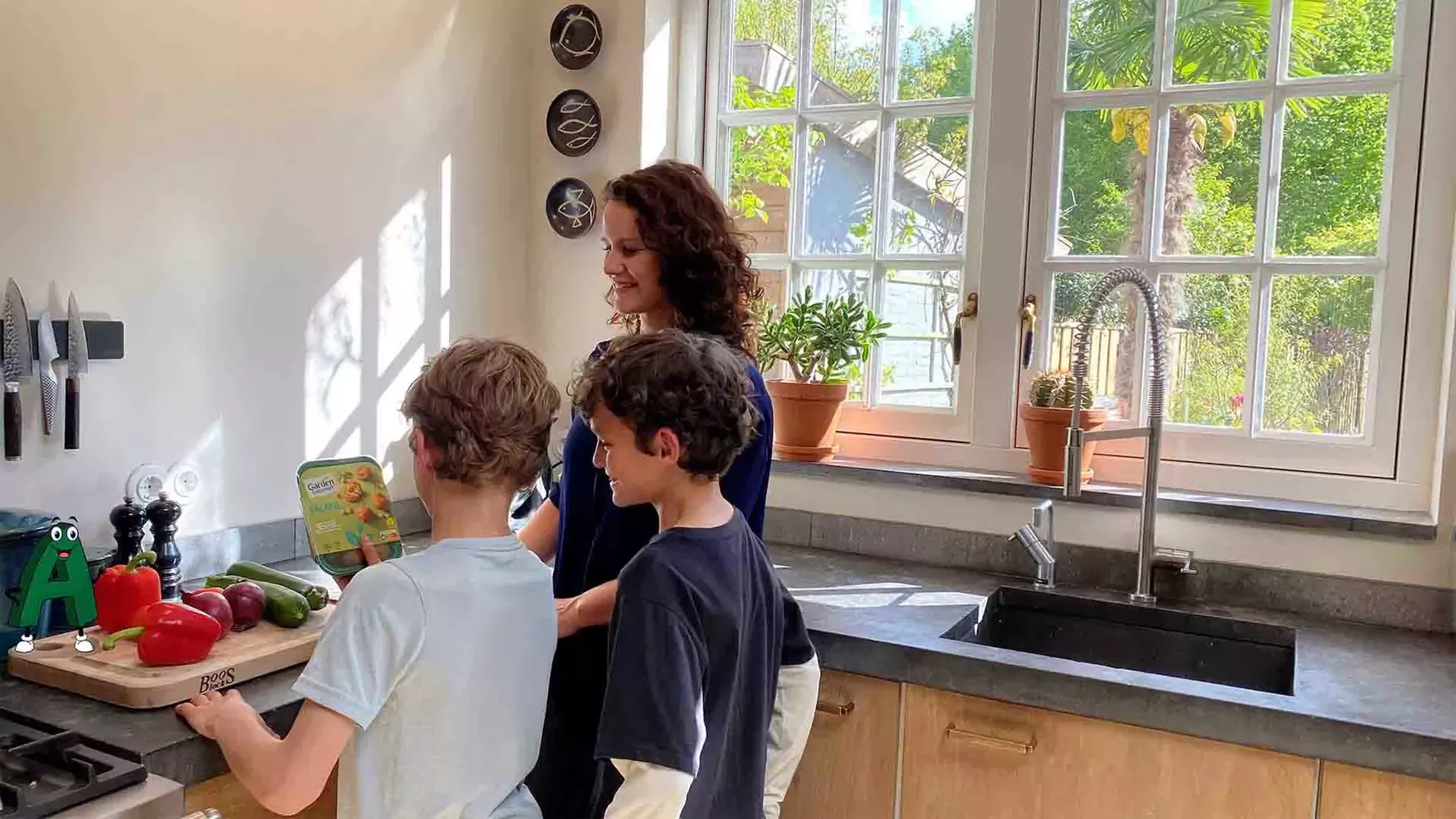 Mom and two boys are cooking