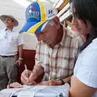 Farmers signing the papers