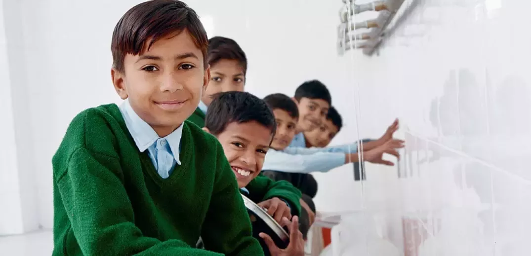 children using drinking water fountain at school