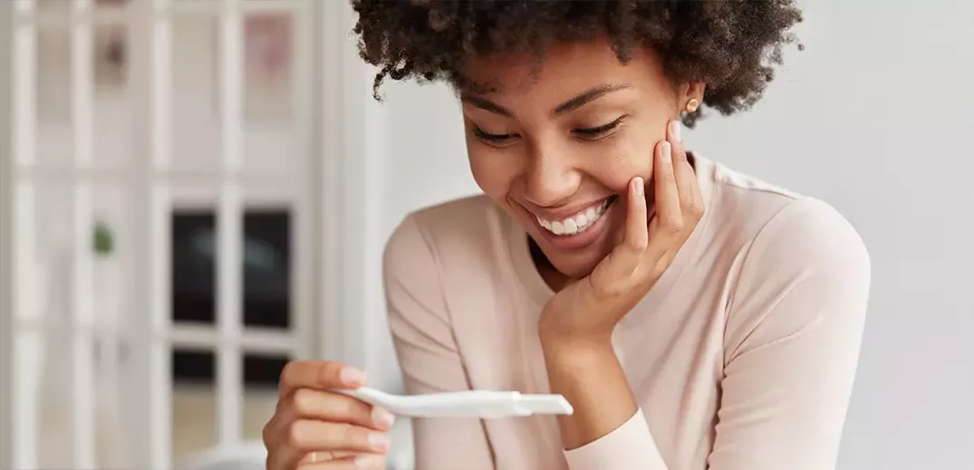 Woman looking at a pregnancy test
