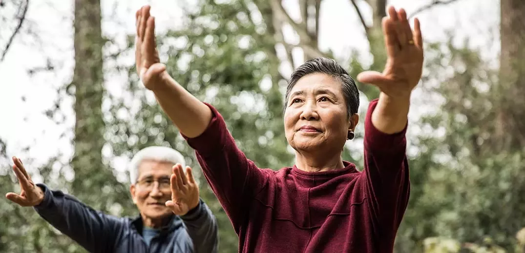 Elder couple doing exercises outside