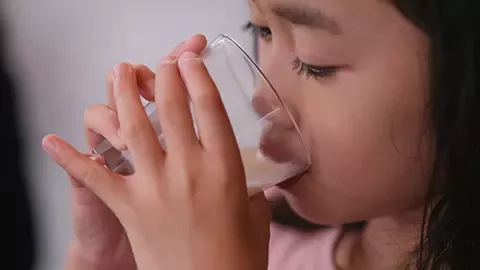 Girl drinking bear brand milk