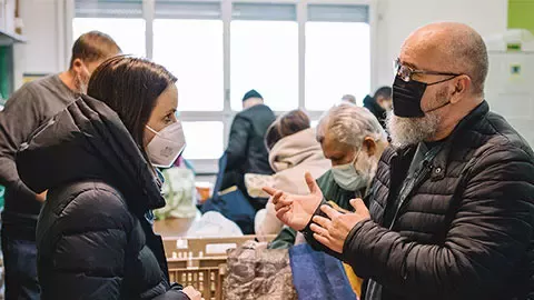 man and woman talking in supermarket