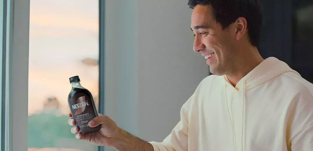 influencer Zach King holding Nescafé Espresso Concentrate bottle