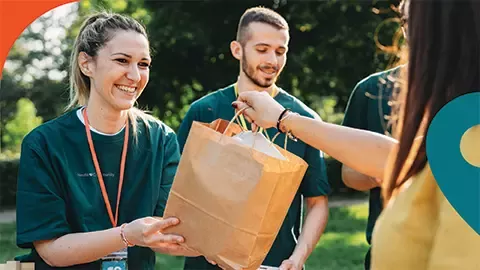 man and woman being given a pack with food