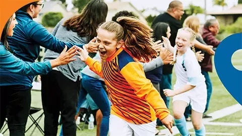 two girls giving high-fives to people