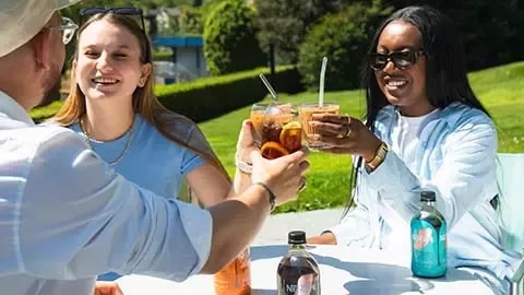 Group of people drinking cold coffee outside