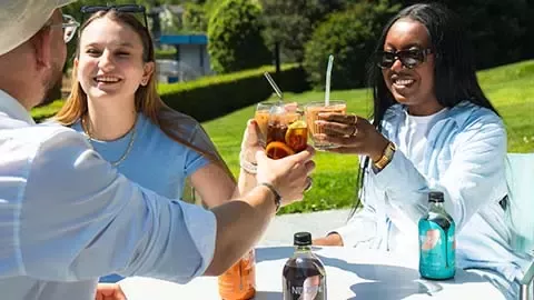 Young people enjoying cold coffee drinks