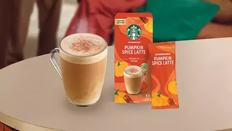 Starbucks pumpkin spice latte coffee and cup of coffee on table