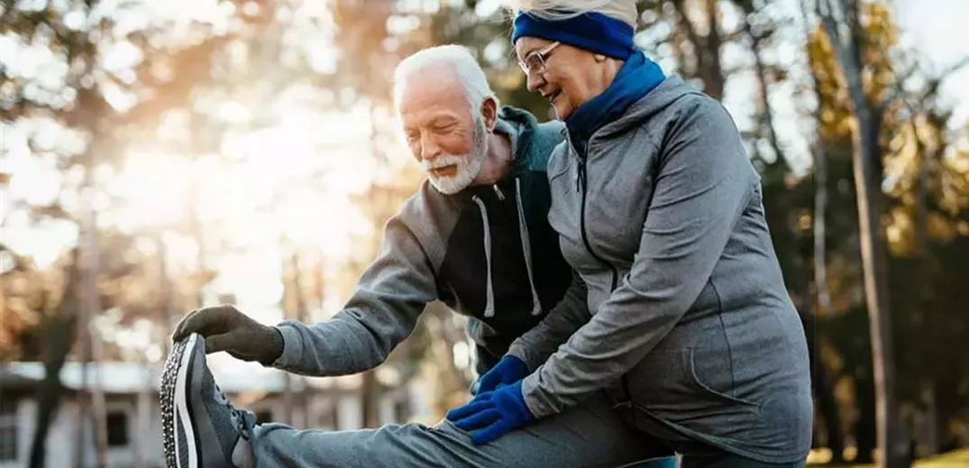 man and woman doing sport exercise in park