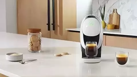 Coffee maker with espresso on kitchen counter.