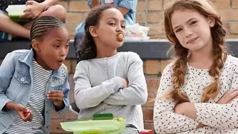 Kids with lunch boxes.