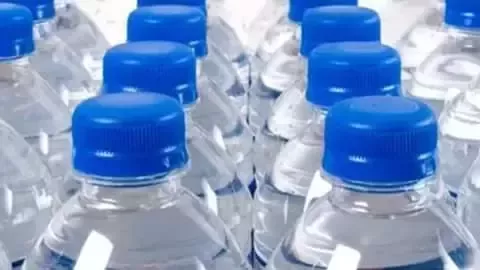 Bottled water with blue caps.