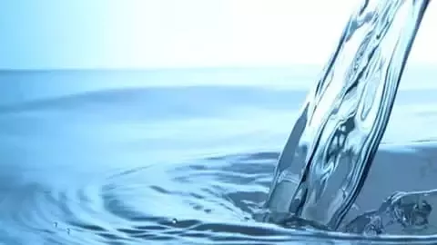 Water flowing into rippling surface.