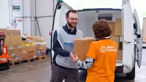 A man hands a box to a woman