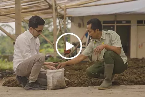 two farmers check the soil