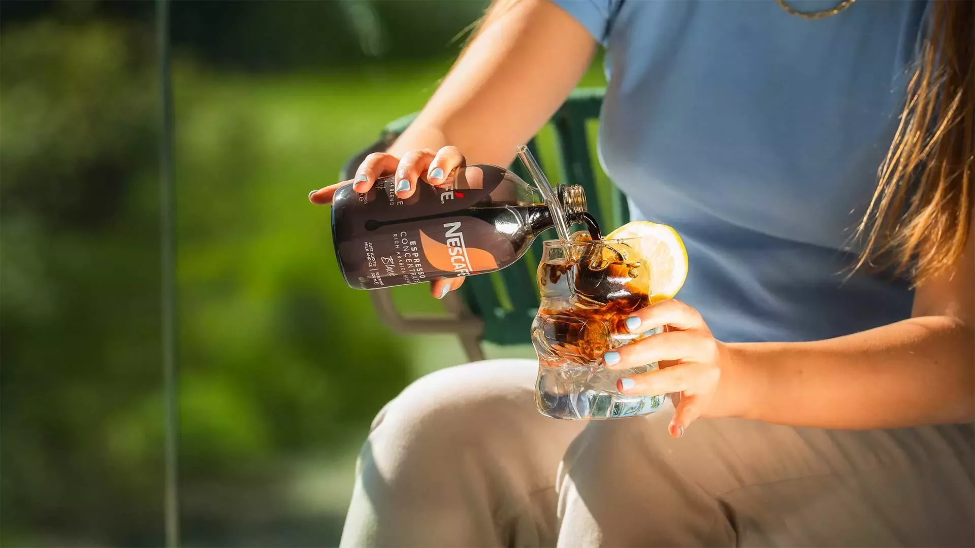 A woman is pouring coffee into a cup