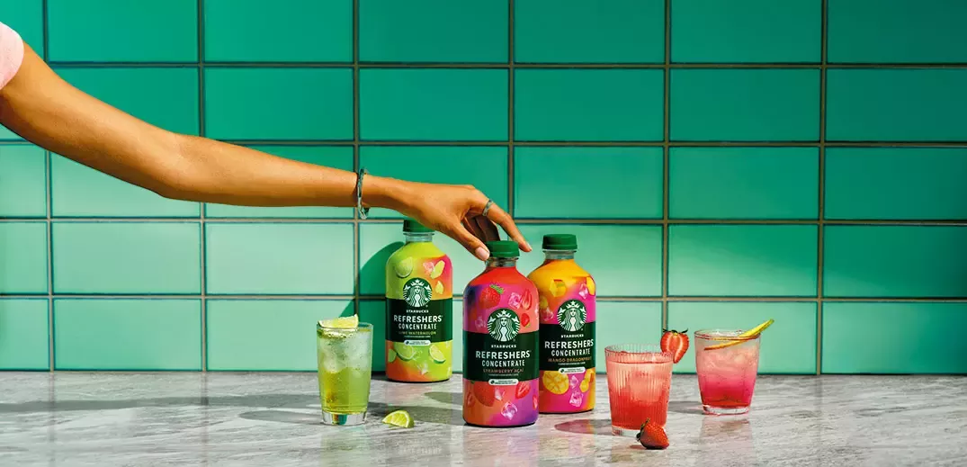 Starbucks Refreshers Concentrate beverages with fruit-inspired drinks on a countertop