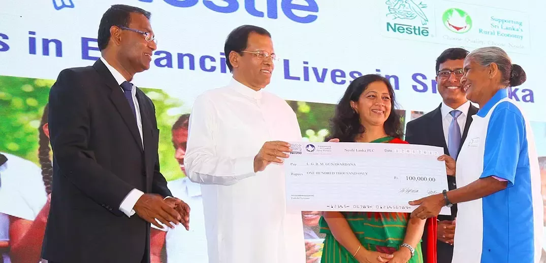 Female dairy farmer receiving a reward