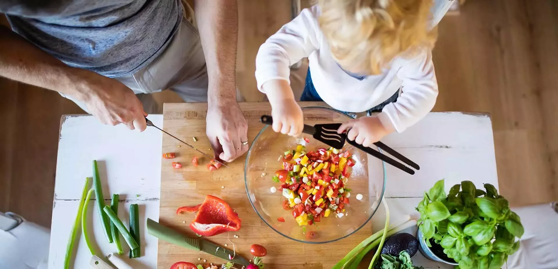 Dad and kid cooking salad