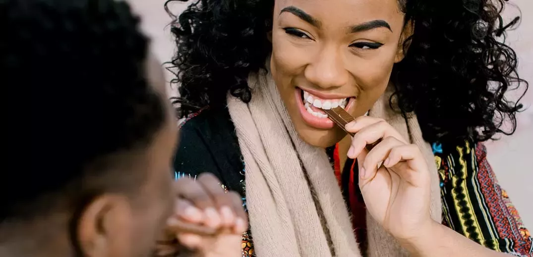 young people sharing a KitKat