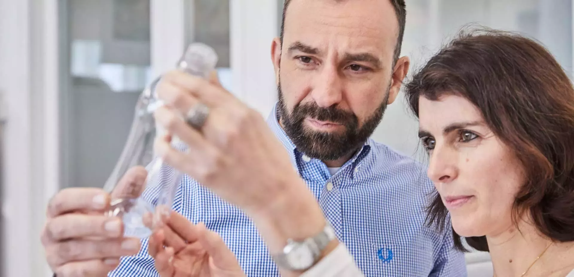 Scientists looking at the bottle