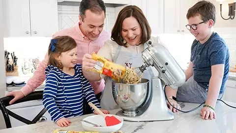 Family making chocolate chip cookies