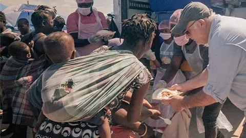 People gathering being served food