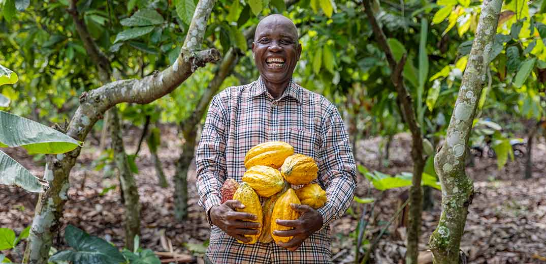 men holding cocoa beens